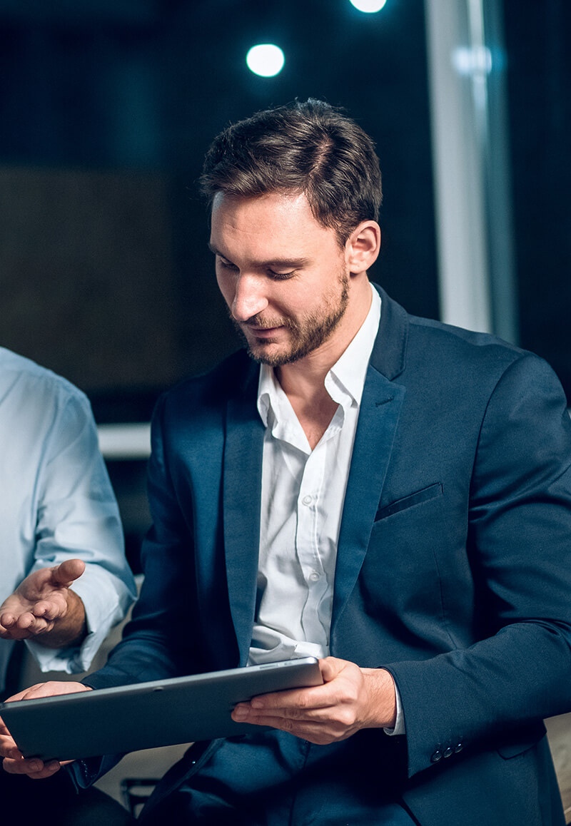 Business man looking at property data on a tablet.